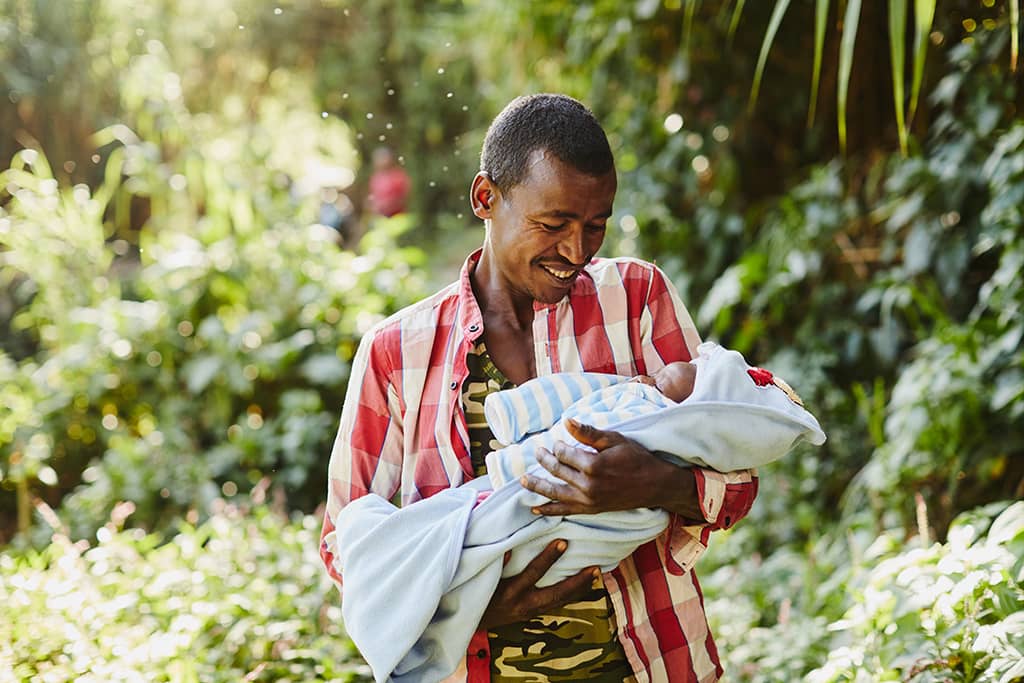 A father in Ethiopia holding his baby