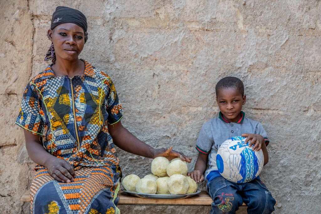 A mother and son receive food in Burkina Faso