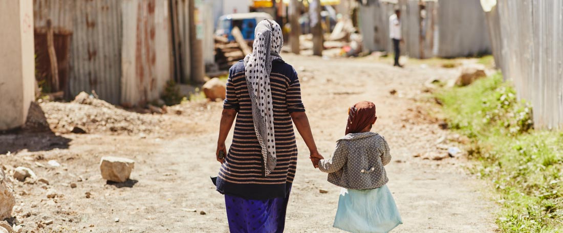 A mother and daughter walk hand in hand in Ethiopia