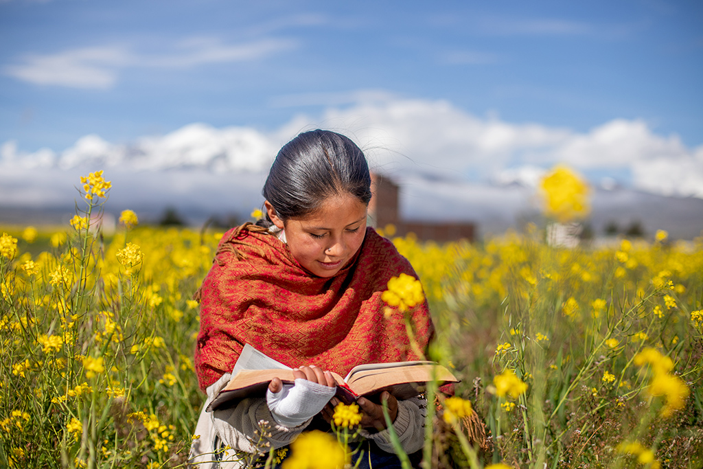 A girl from Bolivia reading her Bible