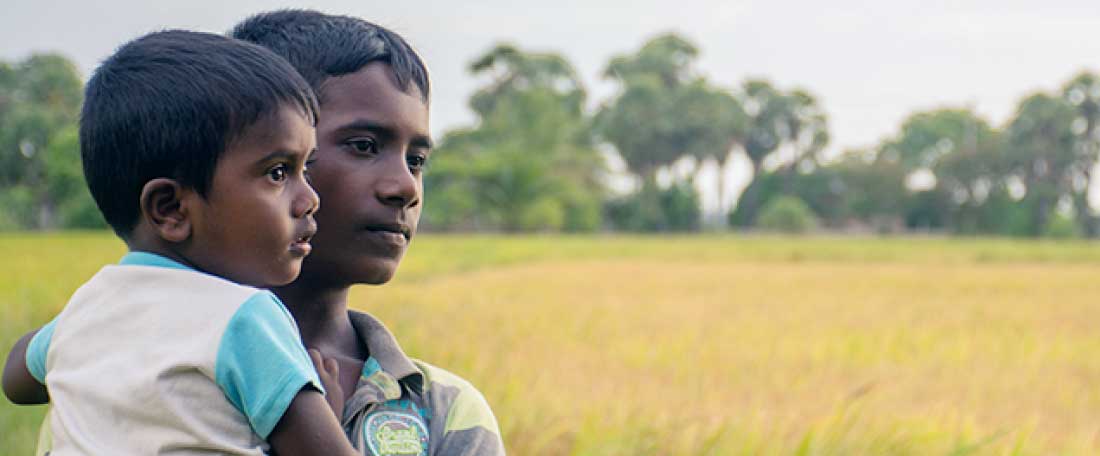 Two boys in a field in Sri Lanka