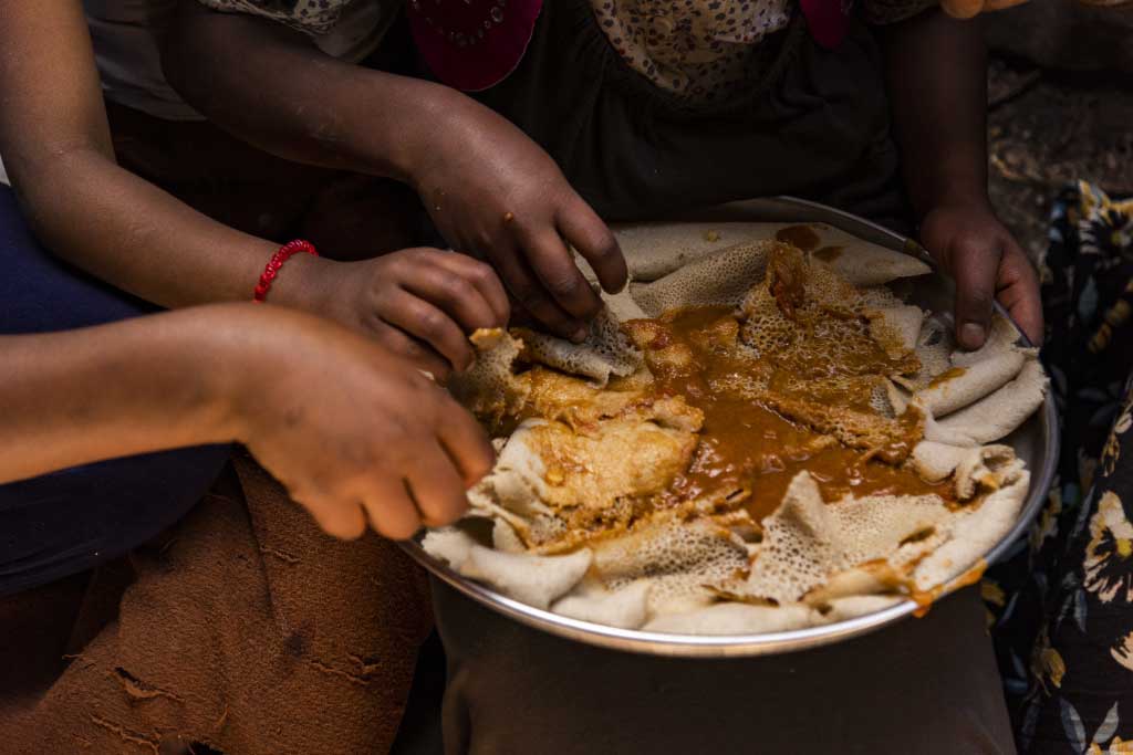 Abiyot, Ethiopia, shares food with her children