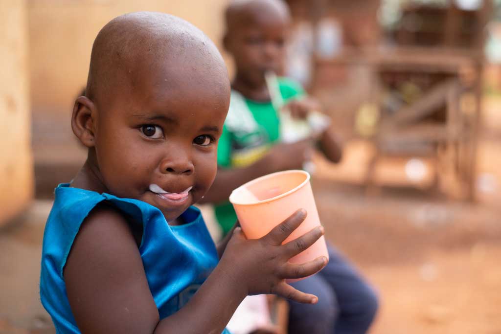 Charity, Uganda, enjoys a nourishing drink