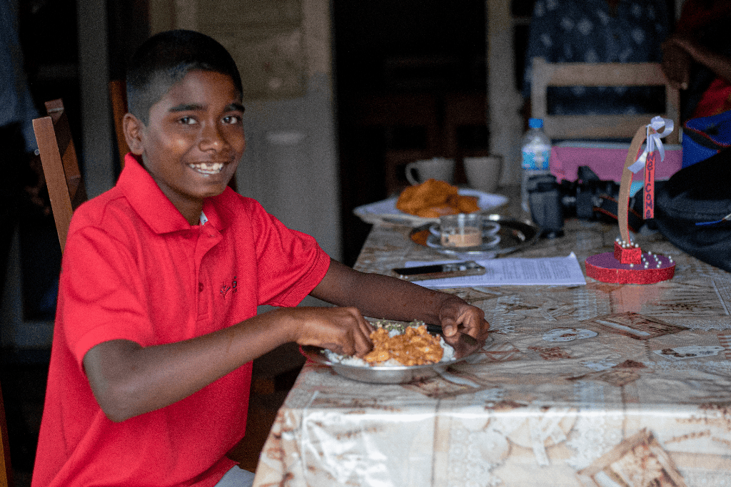 Akshan is eating a healthy meal at the Compassion project.
