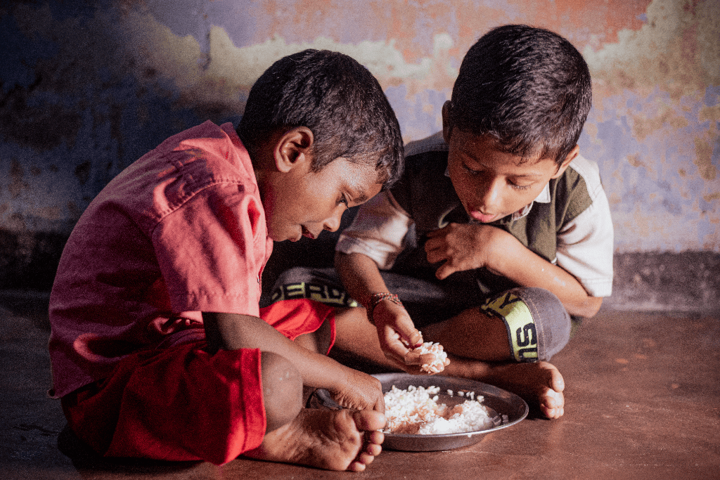 Vengadeshwaram and Vishal are sitting on the floor in their home eating their lunch, a bowl of rice.