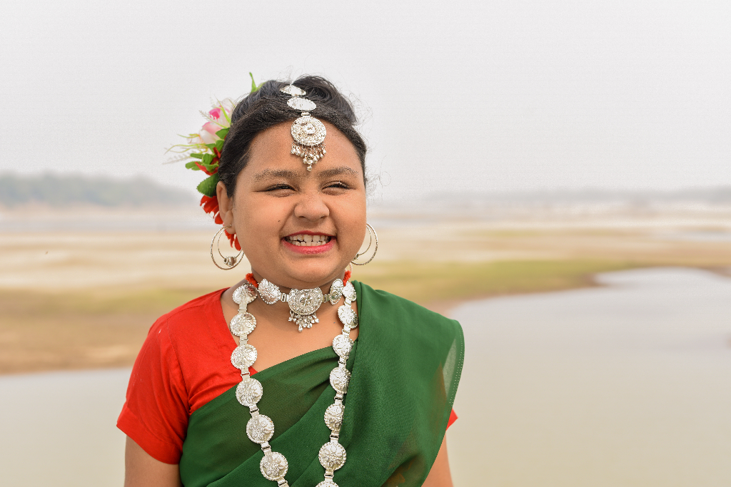 In northeast Bangladesh, the holiday season is cold. The Christmas gift of blankets and new clothes not only warms their bodies, but their hearts too! Raha is wearing a red and green dress. She will be practising her Christmas dance soon!