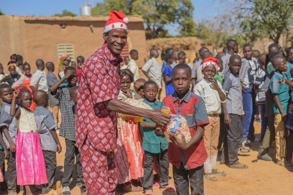 Every child receives a Christmas gift and treats like popcorn and biscuits